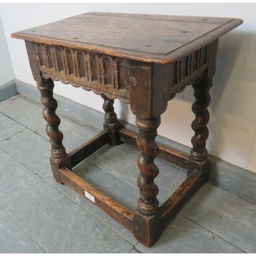 761 - An 18th century oak joint stool in an early 17th century taste, with chisel carved frieze, on barley... 