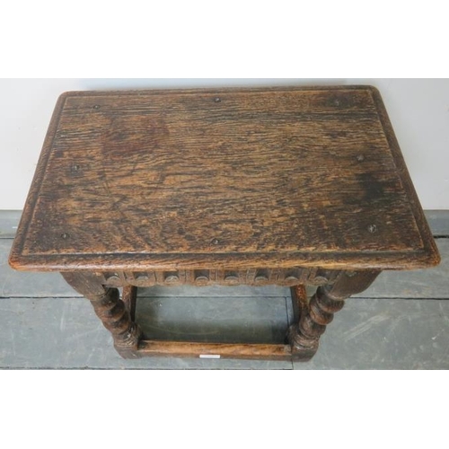 761 - An 18th century oak joint stool in an early 17th century taste, with chisel carved frieze, on barley... 