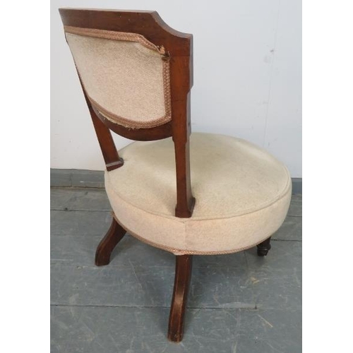 764 - A late Victorian mahogany circular bedroom chair, upholstered in beige buttoned material, on taperin... 