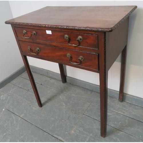 768 - A Georgian mahogany side table with relief carved edge, housing two long cock-beaded drawers with br... 