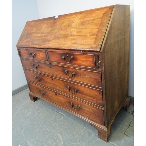 774 - An 18th century walnut bureau, the fall front opening onto a fitted interior with a multitude of sec... 