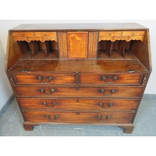 774 - An 18th century walnut bureau, the fall front opening onto a fitted interior with a multitude of sec... 