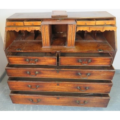 774 - An 18th century walnut bureau, the fall front opening onto a fitted interior with a multitude of sec... 