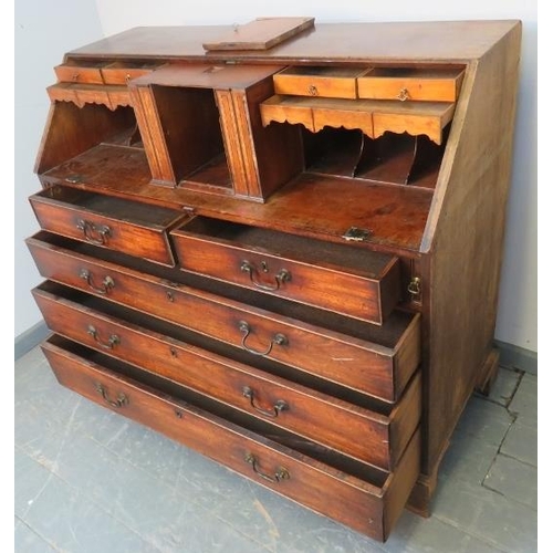 774 - An 18th century walnut bureau, the fall front opening onto a fitted interior with a multitude of sec... 