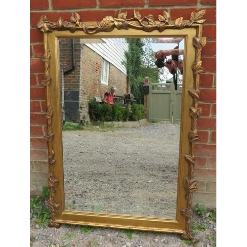 779 - A large rectangular bevelled wall mirror in giltwood frame in the form of fruiting vines. 
Condition... 