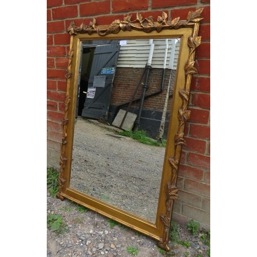 779 - A large rectangular bevelled wall mirror in giltwood frame in the form of fruiting vines. 
Condition... 