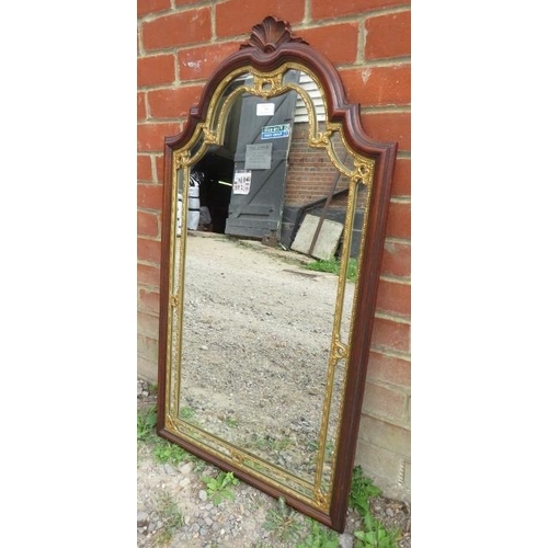 780 - An Edwardian wall mirror with carved shell cornice in a parcel gilt oak frame with pierced tracery d... 