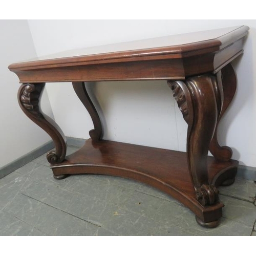 781 - A Victorian mahogany console table, on shell carved and scrolled ogee supports, united by a shaped u... 