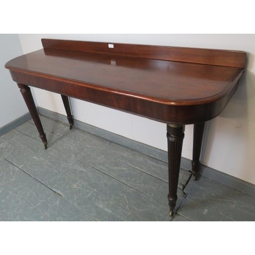 784 - A Victorian mahogany buffet sideboard with rear gallery and reeded edge, on tapering reeded supports... 