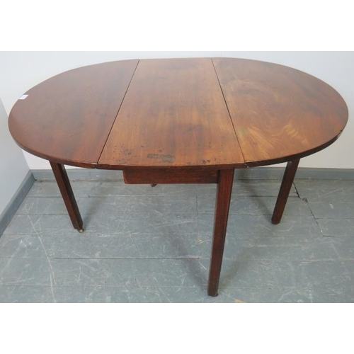 786 - A Georgian mahogany oval drop-leaf table, on inner chamfered square supports with reeded edges, term... 