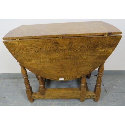 789 - A bespoke medium oak gate-leg table in an 18th century taste, with drawers to either side, on balust... 