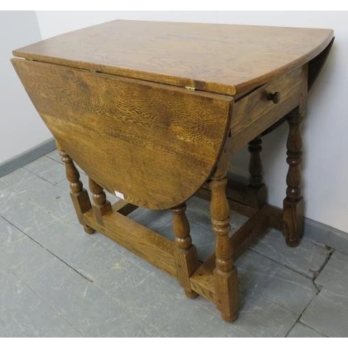 789 - A bespoke medium oak gate-leg table in an 18th century taste, with drawers to either side, on balust... 