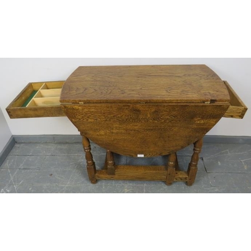 789 - A bespoke medium oak gate-leg table in an 18th century taste, with drawers to either side, on balust... 