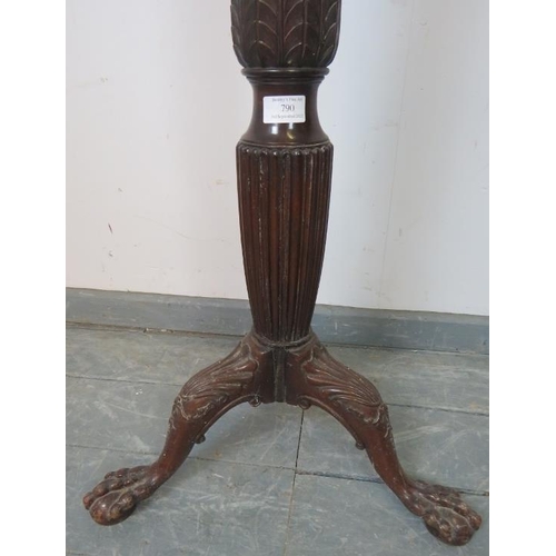 790 - A Victorian mahogany torchere with carved and fluted column, on a shell carved tripod base with claw... 