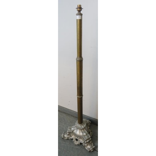 793 - A 19th century telescopic brass standard lamp, on a very ornate cast metal tripod base with scrolled... 