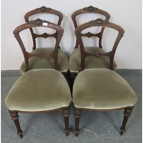 799 - A set of four Aesthetic Period mahogany balloon back dining chairs with carved backs, upholstered in... 