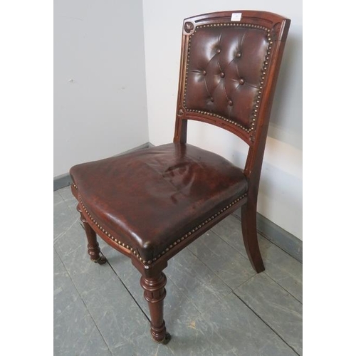 803 - A turn of the century mahogany desk chair upholstered in chocolate brown buttoned brown leather with... 