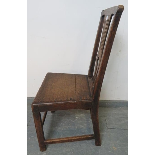 809 - An 18th century oak hall chair with shaped and pierced back splat, on square supports with stretcher... 