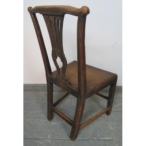 809 - An 18th century oak hall chair with shaped and pierced back splat, on square supports with stretcher... 