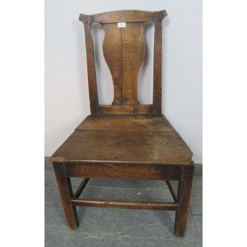 810 - An 18th century elm hall chair with shaped back splat, on inner chamfered square supports with stret... 