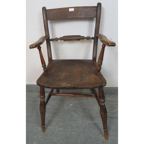 811 - A 19th century elm and beech Oxford bar back Windsor elbow chair, on tapering turned supports with a... 