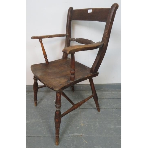 811 - A 19th century elm and beech Oxford bar back Windsor elbow chair, on tapering turned supports with a... 