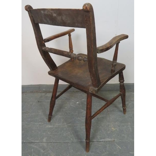 811 - A 19th century elm and beech Oxford bar back Windsor elbow chair, on tapering turned supports with a... 