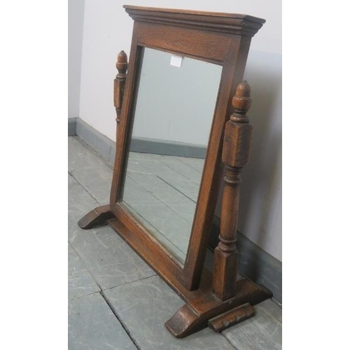 814 - A vintage oak swing vanity mirror in the 18th century taste, with carved cornice and turned and bloc... 