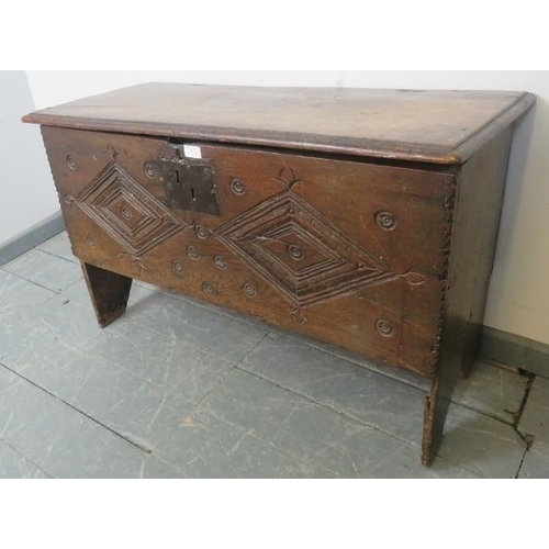 818 - A 17th century oak joined six-plank coffer, featuring original hinges and diamond carved front, on s... 