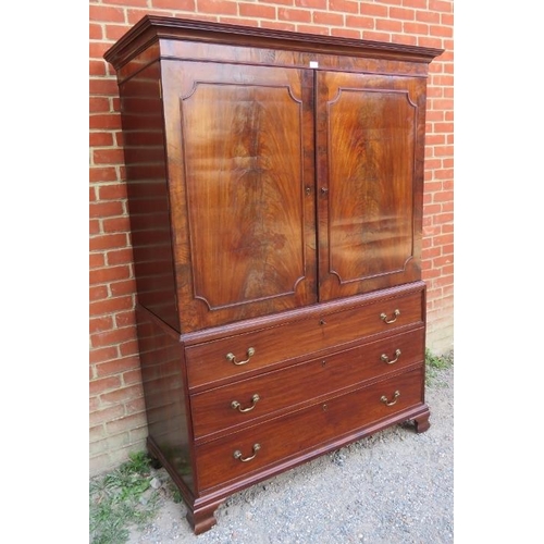 819 - A Georgian flame mahogany linen press, with two cupboard doors over three oak lined graduated cock-b... 