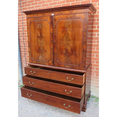 819 - A Georgian flame mahogany linen press, with two cupboard doors over three oak lined graduated cock-b... 