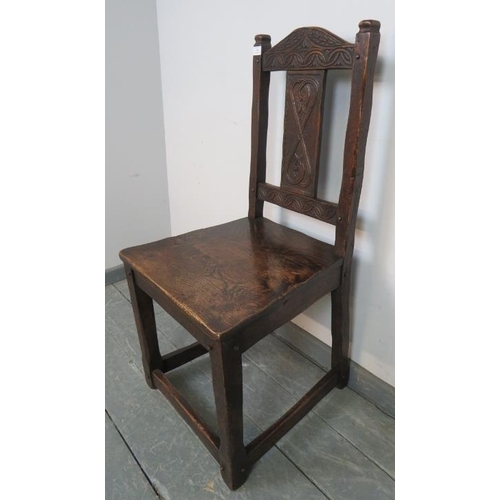 820 - A vintage oak hall chair in a 17th century taste, with relief carved backrest depicting heart motifs... 