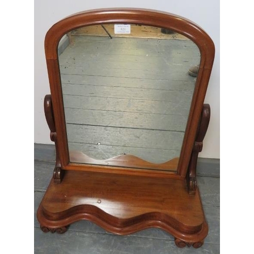 821 - A Victorian walnut swing vanity mirror with shaped uprights and serpentine plinth base, on scrolled ... 