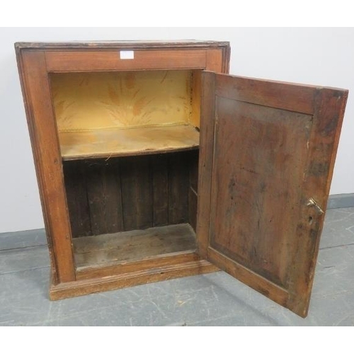 826 - An 18th century elm freestanding cupboard with panelled door and fitted shelf, on a plinth base.
Con... 