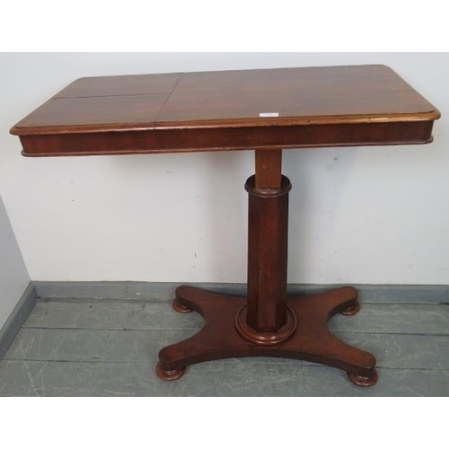 830 - A Victorian walnut reading table, the adjustable book stands with brass rails, on a tapering octagon... 