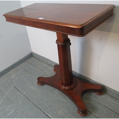 830 - A Victorian walnut reading table, the adjustable book stands with brass rails, on a tapering octagon... 