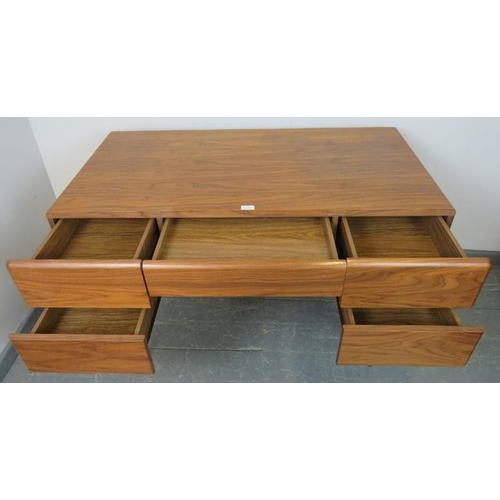 831 - A contemporary walnut desk by Paco, the five long and short drawers with dampened spring-loaded push... 