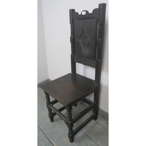 833 - A vintage oak hall chair in the 17th century taste, with carved panel backrest, on ball turned suppo... 