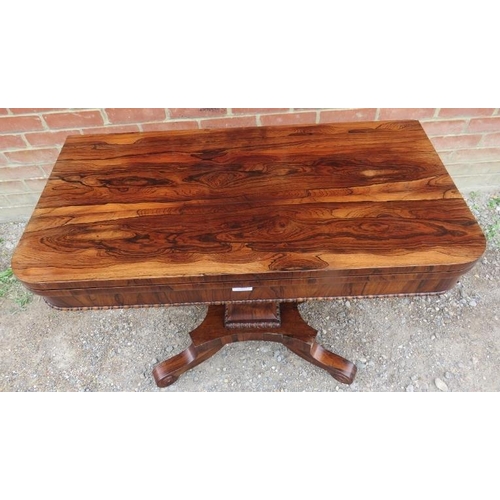 855 - A William IV rosewood turnover card table with inset green baize, featuring gadrooned edging, on a t... 