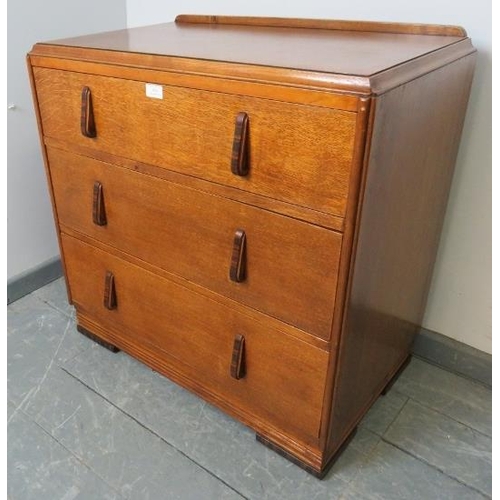 856 - An Art Deco golden oak chest of small proportions, with three long graduated drawers, featuring Maca... 