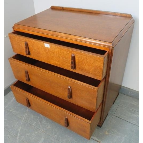 856 - An Art Deco golden oak chest of small proportions, with three long graduated drawers, featuring Maca... 