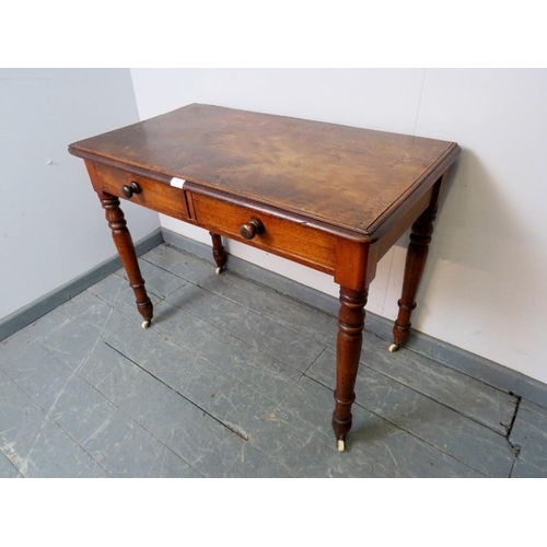 857 - A Victorian walnut hall table, the two short drawers with turned wooden knob handles, on tapering tu... 