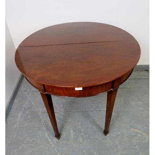 858 - A George III mahogany demi lune folding tea table, on tapering square supports with spade feet. 
Con... 