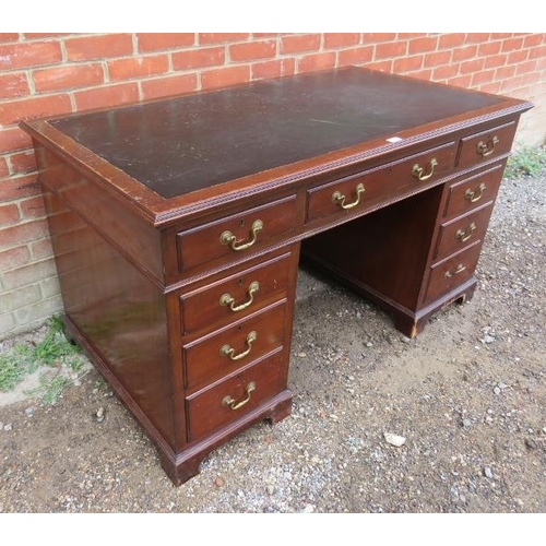 859 - An Edwardian mahogany pedestal desk with inset black leather writing surface, housing a configuratio... 