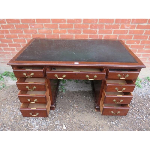 859 - An Edwardian mahogany pedestal desk with inset black leather writing surface, housing a configuratio... 