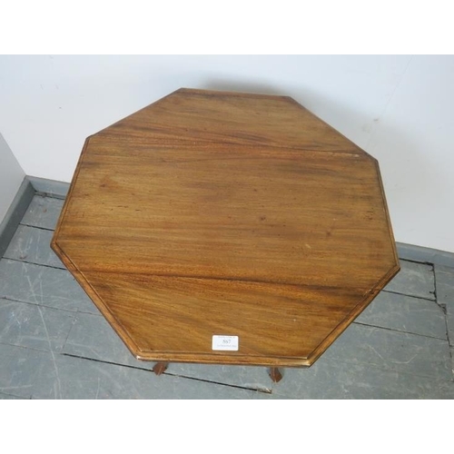 867 - An Edwardian mahogany octagonal occasional table, on turned supports united by a braced undertier. 
... 