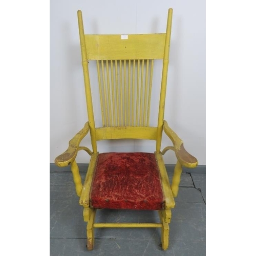 870 - A turn of the century American Arts & Crafts ‘Dexter’ rocking chair, with spindle back and shaped ar... 