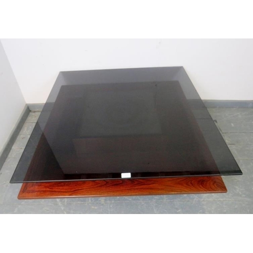 873 - A mid-century hardwood and walnut Danish coffee table by Mobelintarsia, with smoked glass top and si... 