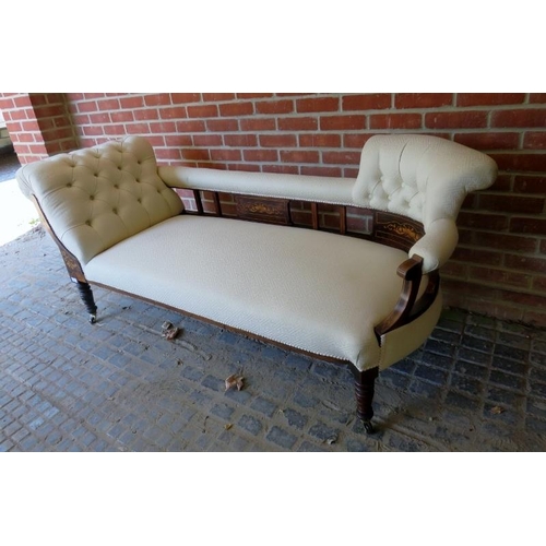 875 - An Edwardian rosewood chaise longue upholstered in buttoned cream material and featuring marquetry i... 