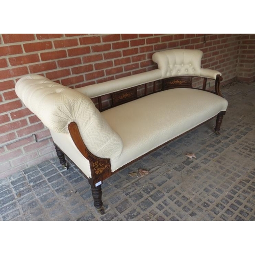 875 - An Edwardian rosewood chaise longue upholstered in buttoned cream material and featuring marquetry i... 